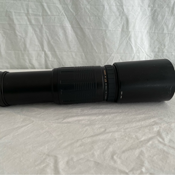 Tameron 200 to 400 telephoto lens black with lens shield.